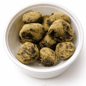 Bhang Goli herbal edibles in a white bowl, pack of 15 pieces for wellness.