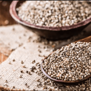 Hemp seeds in a wooden spoon and bowl, rich in nutrients, perfect for a healthy diet.